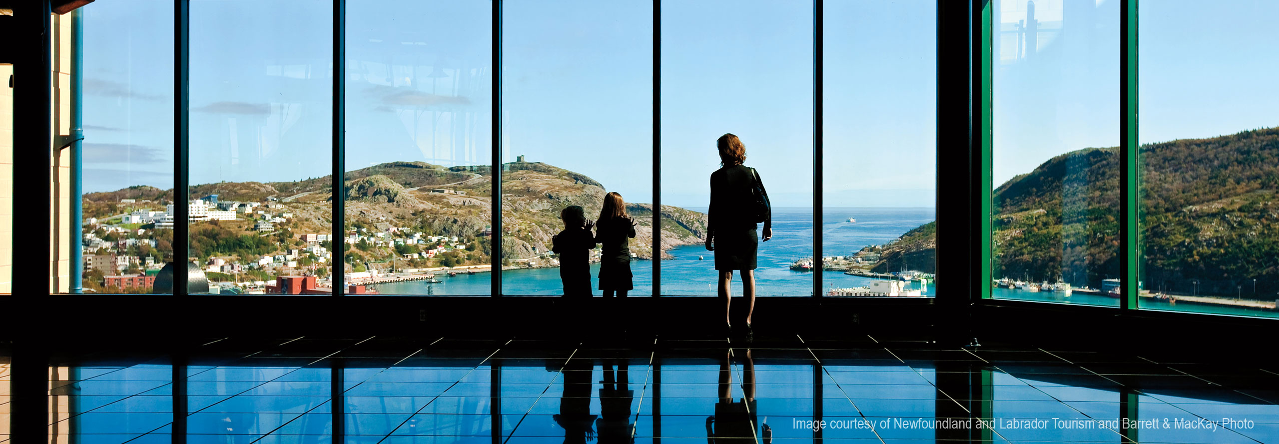 Image courtesy of Newfoundland and Labrador Tourism and Barrett & MacKay Photo Woman and children looking at St. John's from The Rooms